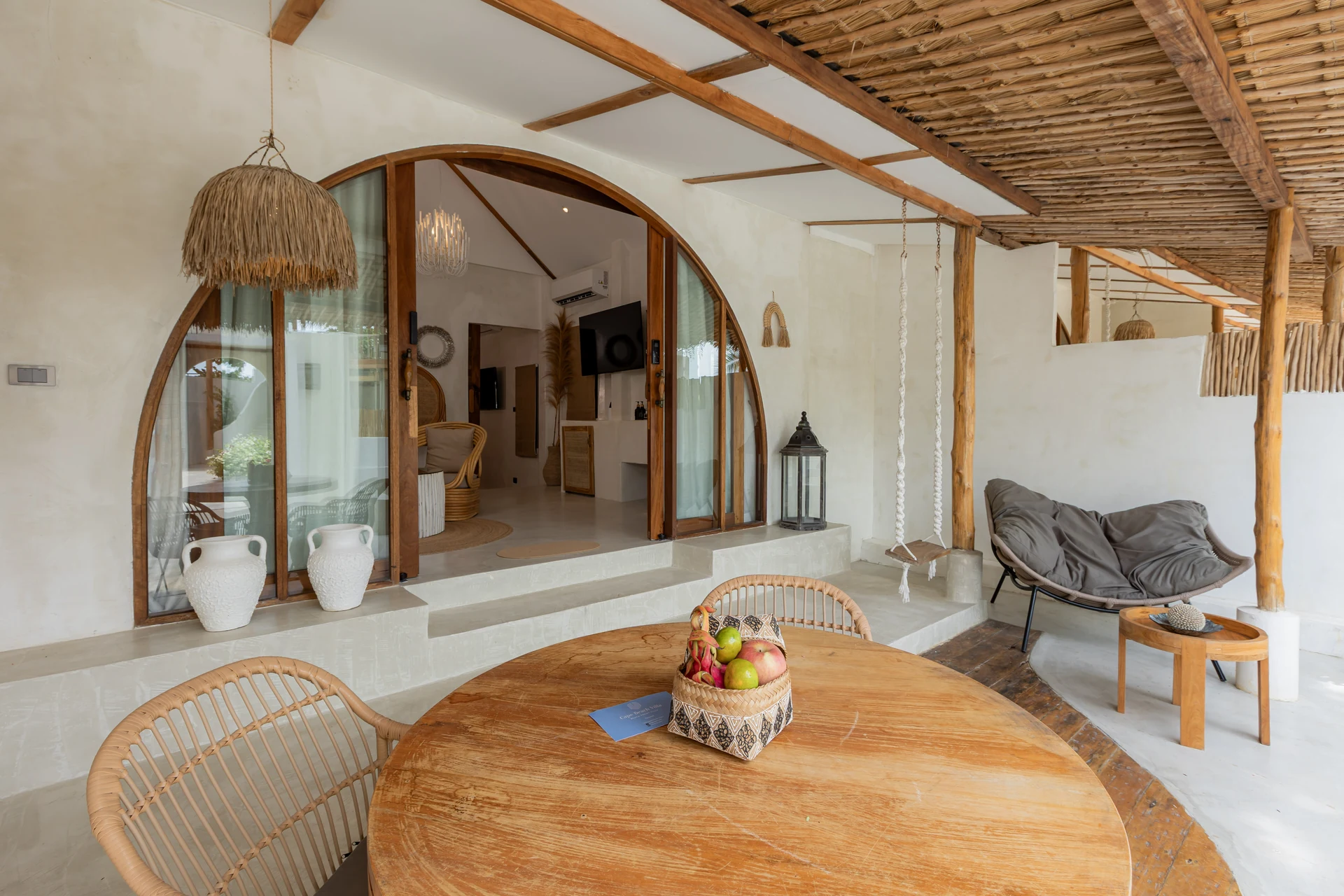 Comfort Villa — boho living room with rattan seating (Villa Ginger) — photo 25